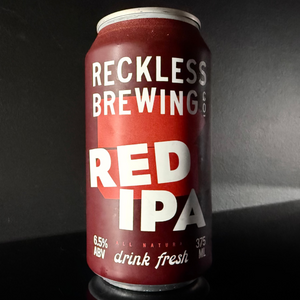 Red IPA beer can from Reckless Brewing on a dark background from y Beer Dealer.